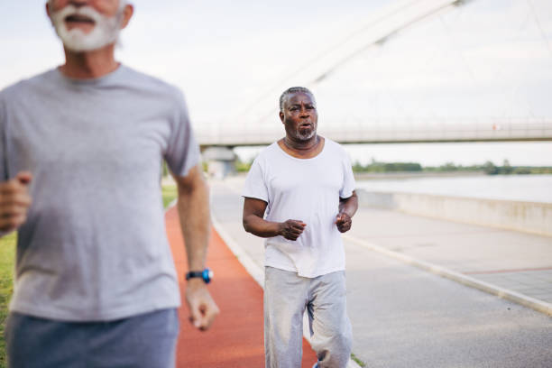 istock Two senior friends training together outside. Diverse Senior Man . 2155848957
