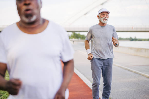 istock Two senior friends training together outside. Diverse Senior Man . 2155848985