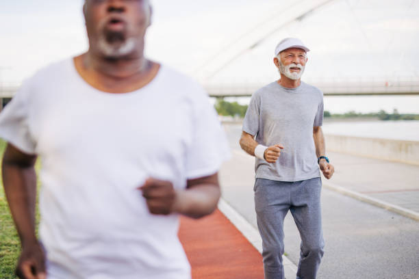 istock Two senior friends training together outside. Diverse Senior Man . 2155848987