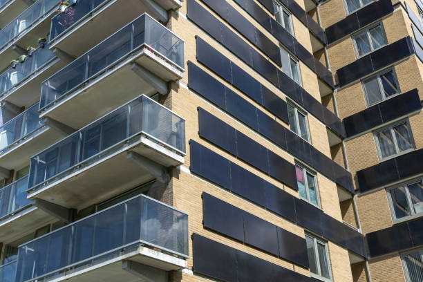 istock Vertical solar panels flat on walls of apartments. 2155850521