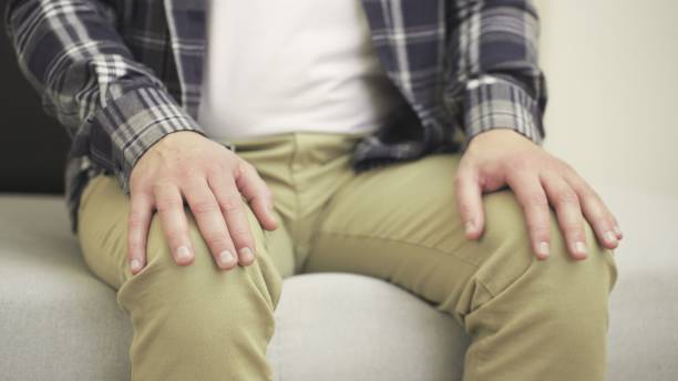 istock Nervous man sitting on sofa while making nervous hand gestures. Slow motion 2155850623