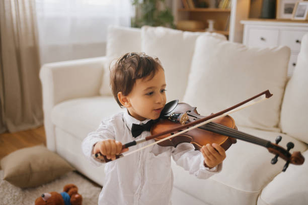 istock Little boy learning how to play violin 2155851026