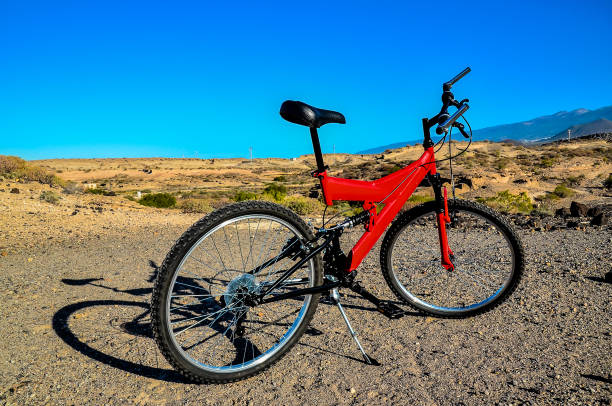 istock A red bicycle is parked on a dirt road 2155851105