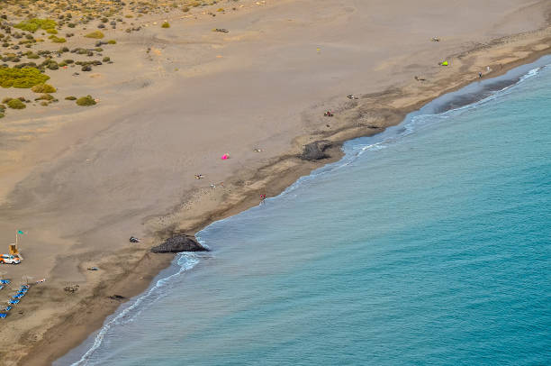 istock A beach with a blue ocean and a few people on it 2155851218