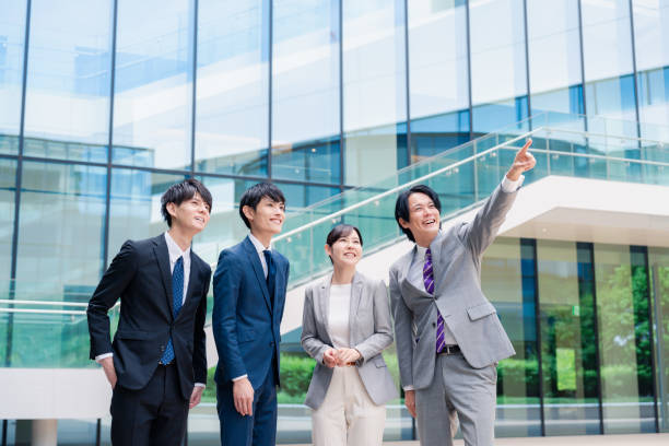 Business people pointing to the future with a smile