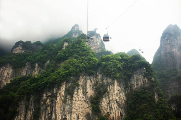 istock View landscape range mountain and cable car cableway for chinese people foreign traveler travel visit Tianmen cave or Heaven Gate in Tianmen Mountain National Forest Park at Zhangjiajie in Hunan China 2155853499