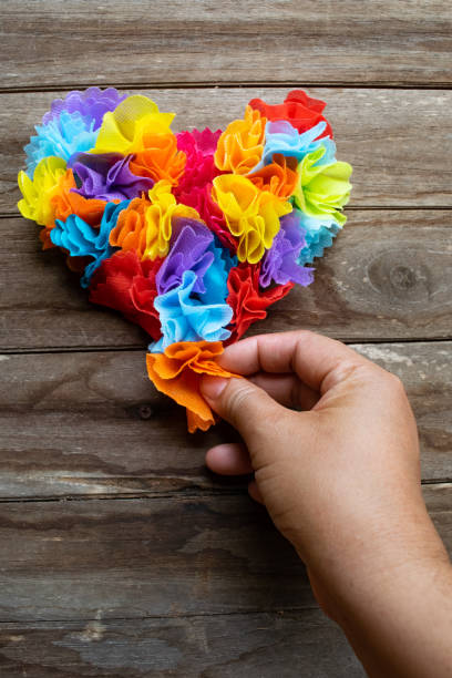 istock Hand holding Coin Paper arranged in Heart Shape 2155855724