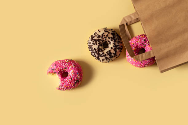 istock Pink and chocolate donuts in craft package 2155859370