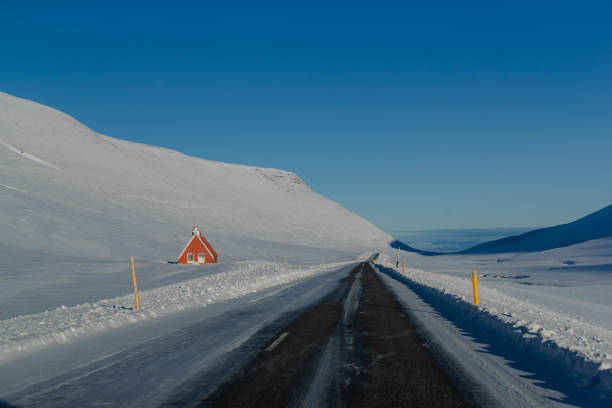 Snow-covered road through mountainous winter landscape
