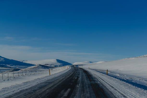 istock Remote farm in snow-covered valley under blue sky 2155864984