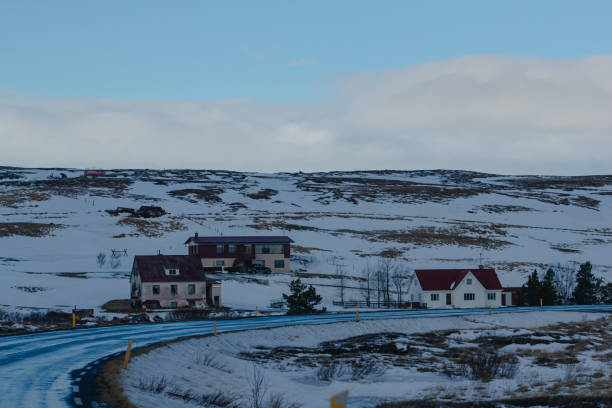 Snow-dusted rural houses along a winding road