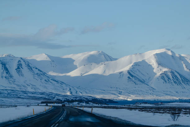 istock Road Leading to Snowy Mountains 2155865039