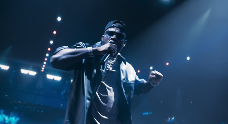 Fans Experiencing a Powerful Musical Performance by a Talented African Hip Hop Artist. Portrait of a Singer Working on Stage With a Blend of Emotion and Energy. Light Show Illuminate the Performer