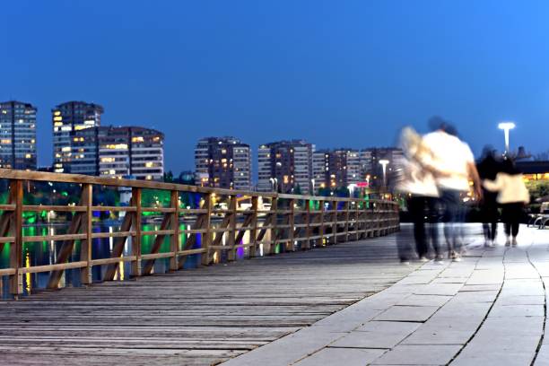 istock Couples walking by the lake in a public park on a weekend evening 2155866475