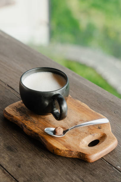 istock Black coffee mug on wooden board with serene green view 2155866580