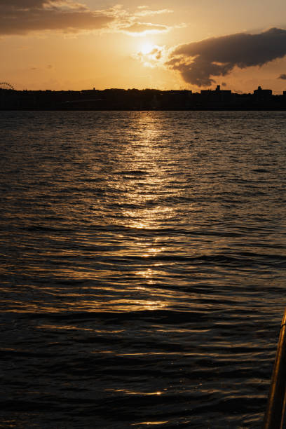 istock Sunset over calm water with golden reflections 2155867172