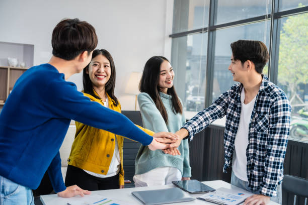 istock university classroom, diverse group of young students Asian collaborate study together, sharing smiles and insights around desks, exemplifying the joy of learning and friendship in higher education. 2155868168