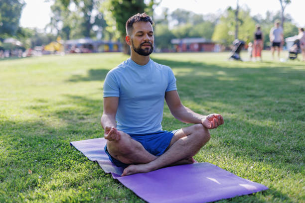 istock Man in meditative yoga pose enjoying nature 2155870030