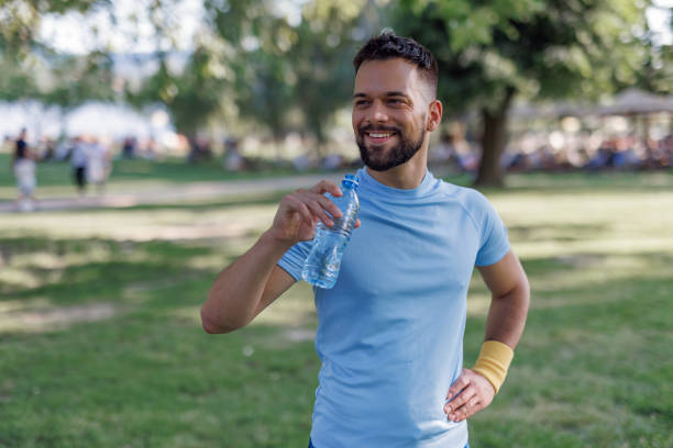 istock Man holding a water bottle smiling 2155870166