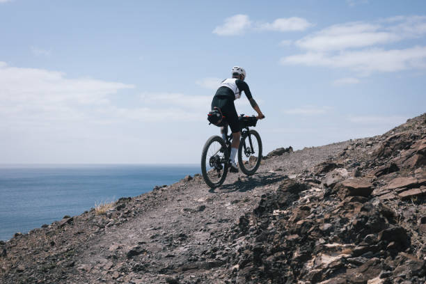 Bikepacker rides through desert landscape