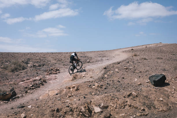 istock Bikepacker rides through desert landscape 2155870182