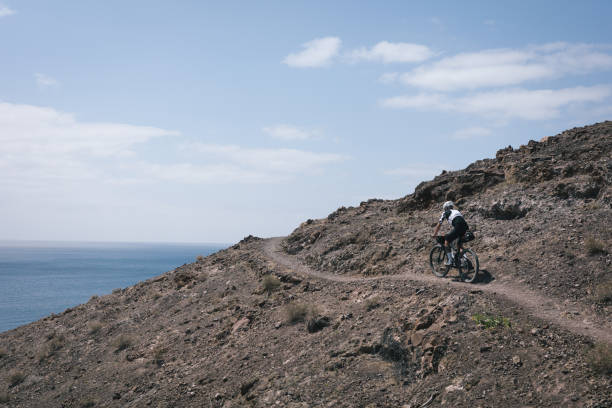 istock Bikepacker rides through desert landscape 2155870238