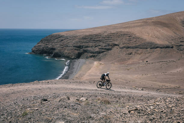 istock Bikepacker rides through desert landscape 2155870296
