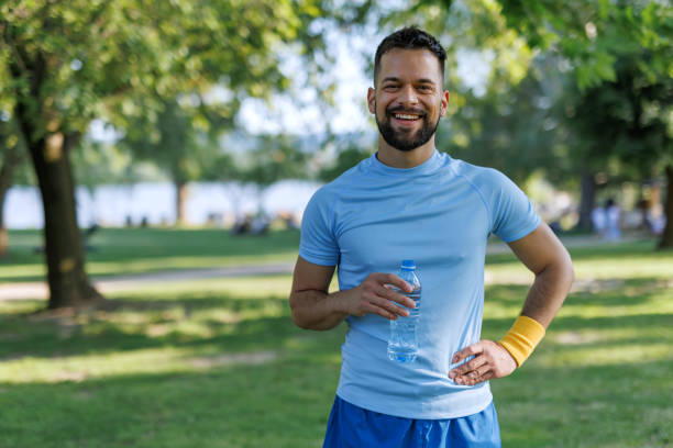 istock Happy athlete holding water bottle 2155870374