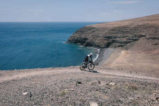 istock Bikepacker rides through desert landscape 2155870431