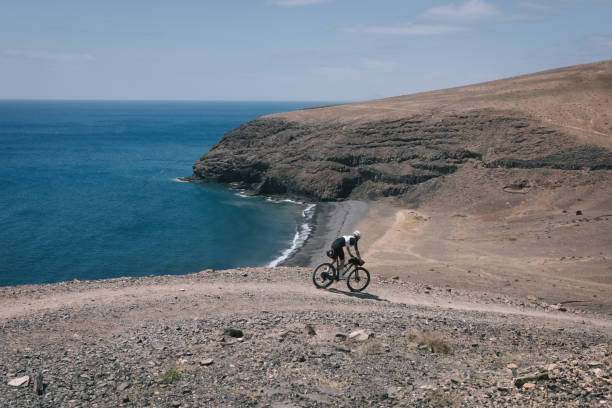 istock Bikepacker rides through desert landscape 2155870434