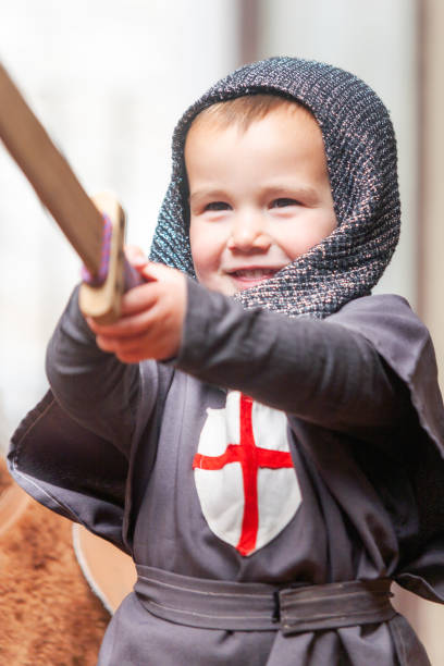 istock Toddler in knight costume with big smile playing with sword. Learning, medieval. 2155870982