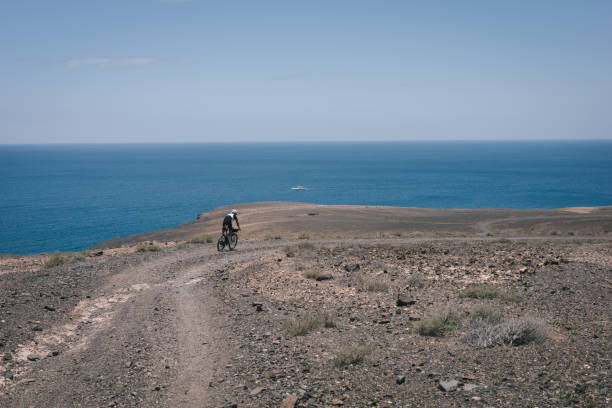 istock Bikepacker rides through desert landscape 2155870992