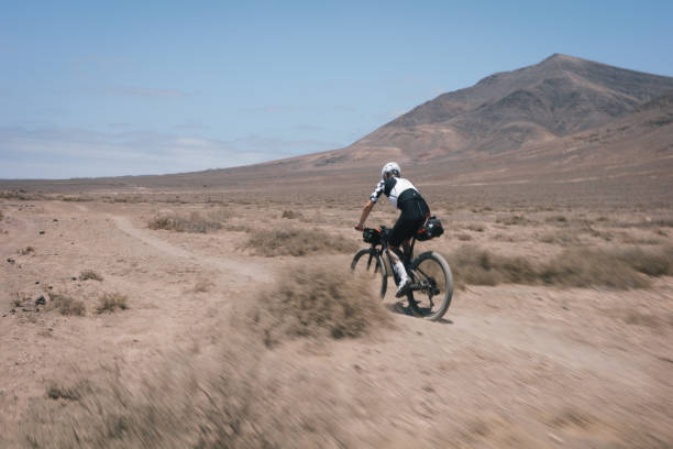 istock Bikepacker rides through desert landscape 2155871027