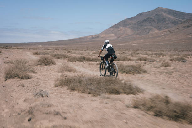 istock Bikepacker rides through desert landscape 2155871028