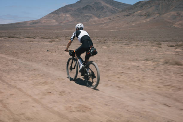 istock Bikepacker rides through desert landscape 2155871046