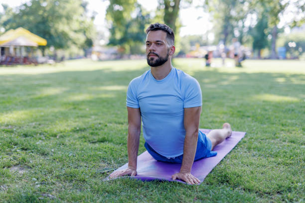 istock Man engaging in upward-facing dog yoga pose 2155871065