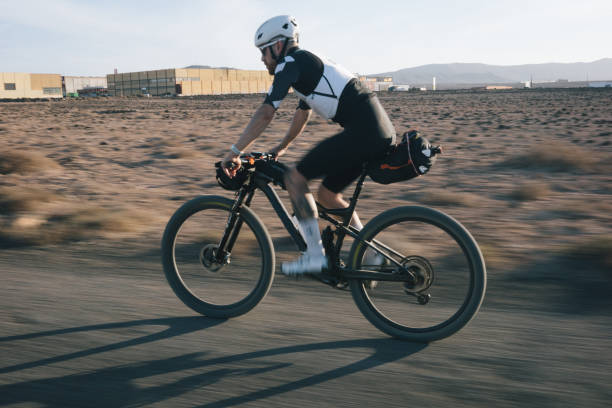 istock Bikepacker rides through desert landscape 2155871604