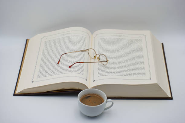 Reading on holidays. Coffee cup and book outdoors. Relaxation resting vacations concept.