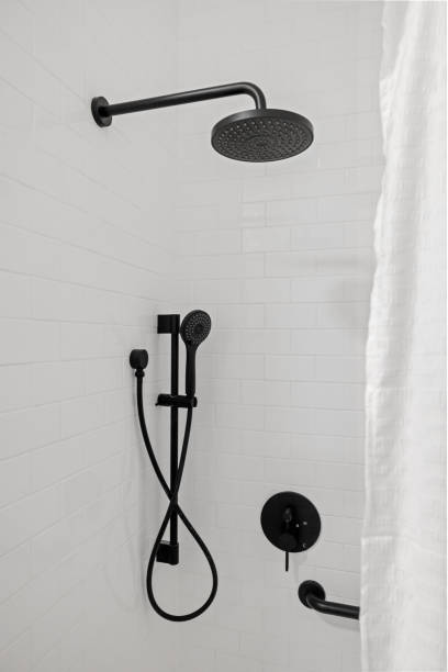istock Shower faucet and handheld shower hose mounted on a tiled shower wall. 2155873964