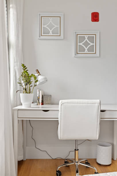 istock a white desk in a bright white bedroom with wood floors 2155874043