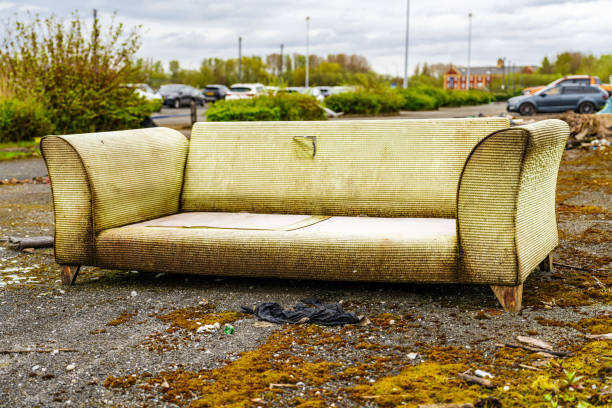 istock Fly tipping, rubbish dumped illegally by the road side. Large sofa, environmental issue. 2155876034
