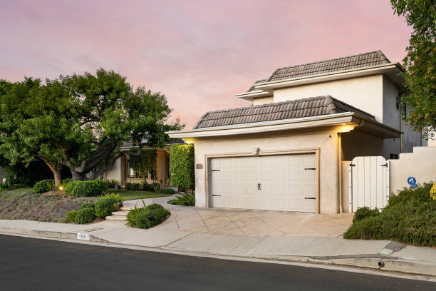 istock Driveway bordered by numerous trees and shrubs in Encino, California 2155877554