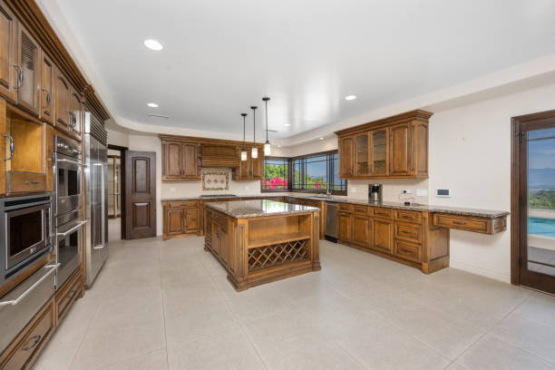 istock Kitchen with cabinets, table, and windows in Encino, California 2155877604