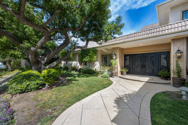 istock Luxury home with expansive green backyard, featuring lush trees in Encino, CA 2155877627