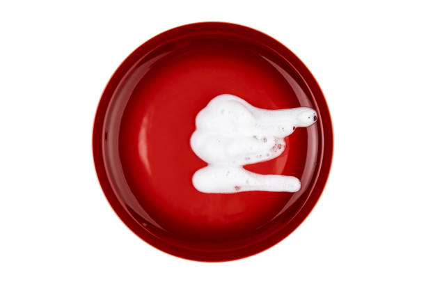 Red plate with foam isolated on white top view
