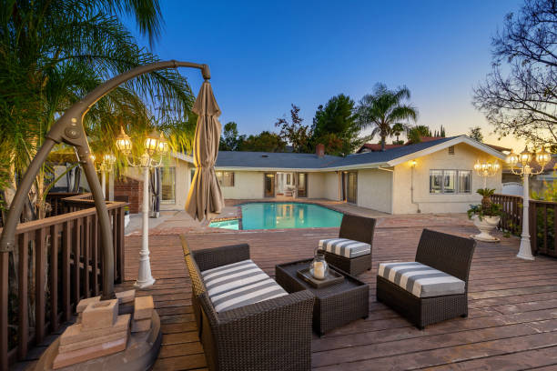 A patio with seating and a pool outdoors in Encino, California