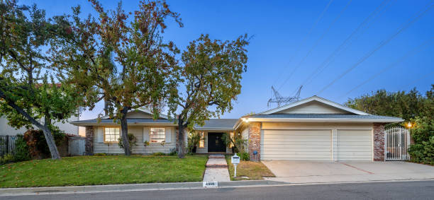 istock One-story house with front driveway, flanked by two trees in Encino, CA 2155877778