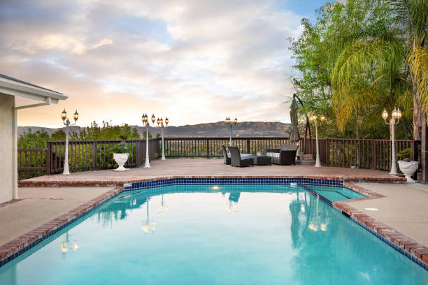 istock Empty swimming pool surrounded by trees and a fence in Encino, CA 2155877819