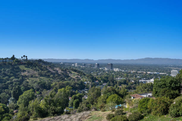 istock Lush green hill, trees, rolling hills, and clouds in Hidden Hills, CA 2155877835