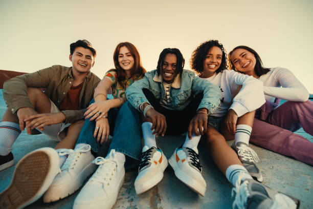 istock Gen Z friends sitting together outdoors, posing and smiling 2155877901